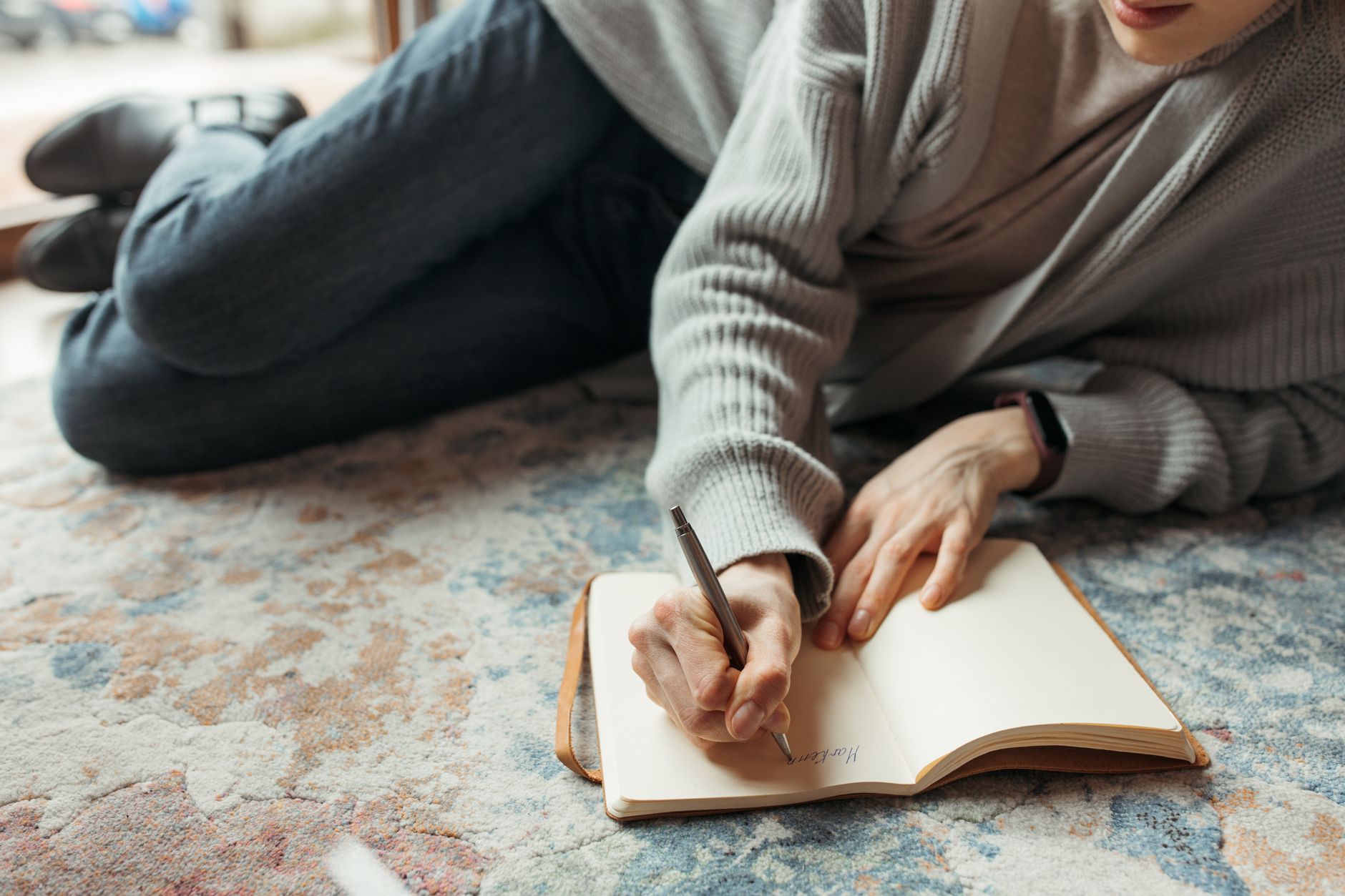 Travel writer sitting in mountain cabin reviewing field notebook